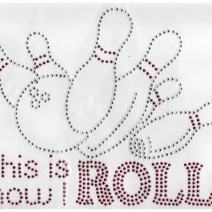May include: A white background with a silver and maroon rhinestone design of bowling pins and a bowling ball. The text "This is how I roll" is written in maroon rhinestones.
