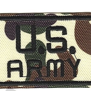 May include: A black and white embroidered patch with a camouflage background. The patch says "U.S. ARMY" in black lettering.