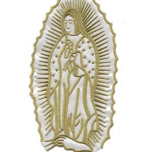 May include: Gold embroidered patch of the Virgin Mary, also known as Our Lady of Guadalupe, on a white background.