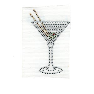 May include: A rhinestone-studded martini glass design. The glass features a triangular bowl filled with silver rhinestones, a green olive, and two gold-colored stir sticks. The stem and base are also outlined with rhinestones.