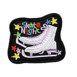 May include: Black iron-on patch with white ice skate and colorful text that says "Skate Night" with stars around the skate.