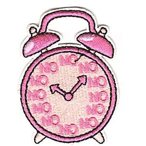 May include: Pink embroidered alarm clock with a white face and black hands. The clock face has the word "No" repeated around the edge.