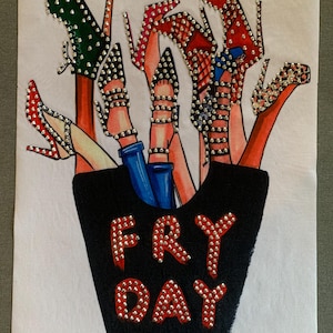 May include: A white fabric art piece featuring a black container with the text "FRY DAY" in red, embellished with silver studs. Above the container, various high heels in red, green, and leopard print are depicted, also adorned with studs.