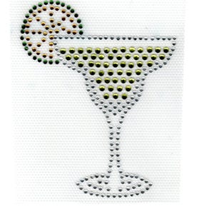 May include: A rhinestone design of a margarita cocktail with a lime slice. The cocktail glass is filled with silver and gold rhinestones, and the lime slice is green and gold. The design is on a white background.