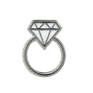 May include: A silver ring with a large diamond-shaped stone. The ring is a simple design with a smooth band.