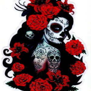 May include: A colorful illustration of a sugar skull woman with red roses and lilies. The woman has a detailed sugar skull face with black eyes and a black floral tattoo on her arm.