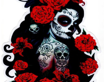 May include: A colorful illustration of a sugar skull woman with red roses and lilies. The woman has a detailed sugar skull face with black eyes and a black floral tattoo on her arm.
