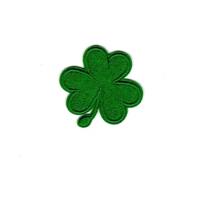 May include: A green four-leaf clover patch.