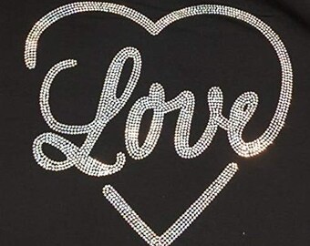 May include: A black t-shirt with a rhinestone design of a heart with the word "Love" inside.
