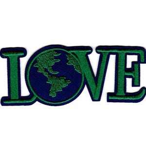 May include: Embroidered patch featuring the word "LOVE" in green, with the letter "O" replaced by a blue circle containing a green embroidered world map. The patch has a white background.