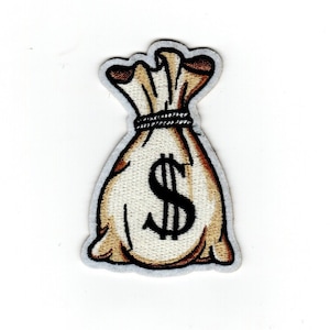 May include: Embroidered patch featuring a money bag design. The bag is beige with brown shading and a black dollar sign. A black rope ties the top of the bag. The patch has a white border.