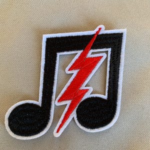 May include: Black and white musical note with a red lightning bolt inside. The patch is embroidered and has a white border.