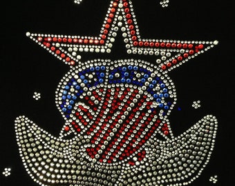 May include: A red, white, and blue star with a red, white, and blue anchor underneath. The star and anchor are made of rhinestones.