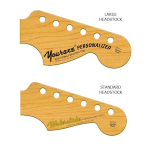 May include: Two guitar headstock templates, one with a large headstock and one with a standard headstock. Both templates are made of wood and have a natural finish. The large headstock template has the text "Your axe PERSONALIZED" and "ADDITIONAL PERSONAL TEXT" printed on it. The standard headstock template has the text "Waterslide PERSONALIZED DECAL" and "ADDITIONAL PERSONALIZATION TEXT" printed on it.