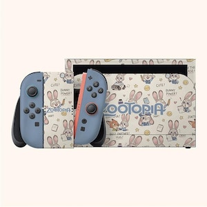 May include: A Nintendo Switch console and controllers featuring a Zootopia theme. The controllers are blue and coral, with a cream-colored case and controllers covered in Zootopia character illustrations and text.