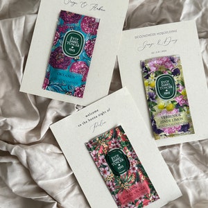May include: Three small packets of cologne with floral designs. The packets are labeled with the brand name "Eyüp Sabrı Tuncer 1923". The scents are "Okyanus", "Verbena & Zinde Limon", and "Japon Kiraz Çiçeği".