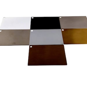 May include: A collection of nine metal color swatches arranged in a grid. The swatches include white, black, silver, brown, gray, and gold. Each swatch has a small hole in the corner.