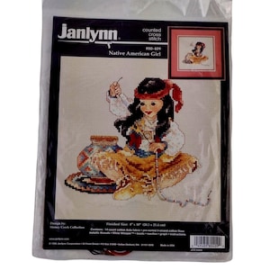May include: A Janlynn counted cross stitch kit with a Native American Girl design. The kit includes 14-count cotton Aida fabric, pre-sorted cotton floss, metallic threads, beads, needles, and instructions. Finished size is 20.3 cm x 25.4 cm.