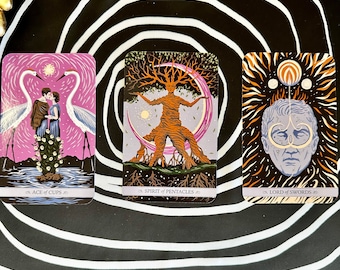 May include: Three tarot cards with colorful illustrations. The "Ace of Cups" card depicts a couple with two white birds. The "Spirit of Pentacles" card shows a tree-like figure. The "Lord of Swords" card features a face with a halo.