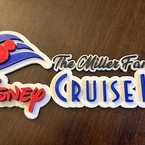 May include: A white 3D printed sign with the text "Disney Cruise Line" in blue and red letters. The sign also includes a blue and white Mickey Mouse ship logo and the text "The Miller Family" in black.