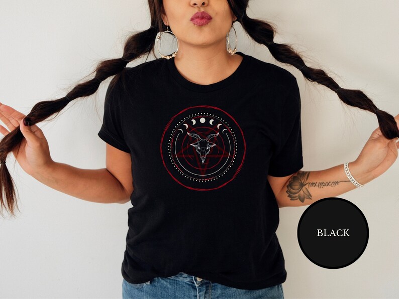Wiccan witch wearing black goth Satanic witch shirt that features Baphomet, moon phases, magical circles, and a pentagram for the ultimate gift for a witch or a fan of witch horror.