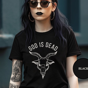 May include: Black t-shirt with a white graphic of a goat's head and the text "God is Dead".