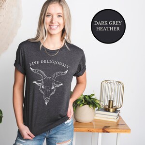 Blonde Cottagecore Witch wearing dark heather grey witch tshirt that reads Live Deliciously with Baphomet Black Phillip goat head on the front