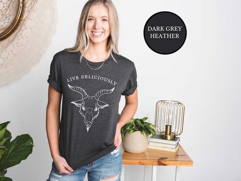 Blonde Cottagecore Witch wearing dark heather grey witch tshirt that reads Live Deliciously with Baphomet Black Phillip goat head on the front