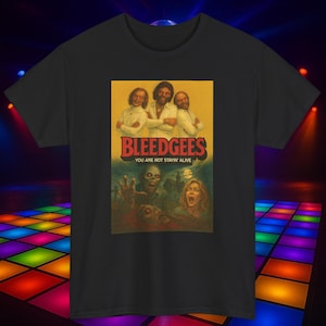May include: Black t-shirt featuring a parody design. The graphic includes the text "BLEEDGEES" above an image of a zombie scene. The phrase "YOU ARE NOT STAYIN' ALIVE" is below the image. The design is in a vintage style.