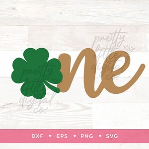 May include: A green four-leaf clover and the word "one" in brown script. The text "pretty little digital co." is written in white script on the clover and the word "one".