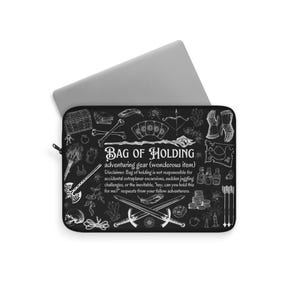 May include: Black laptop sleeve with the text "BAG OF HOLDING" and various white illustrations of adventure-themed items. Includes crossed swords, a treasure chest, and potion bottles. A laptop is partially visible.