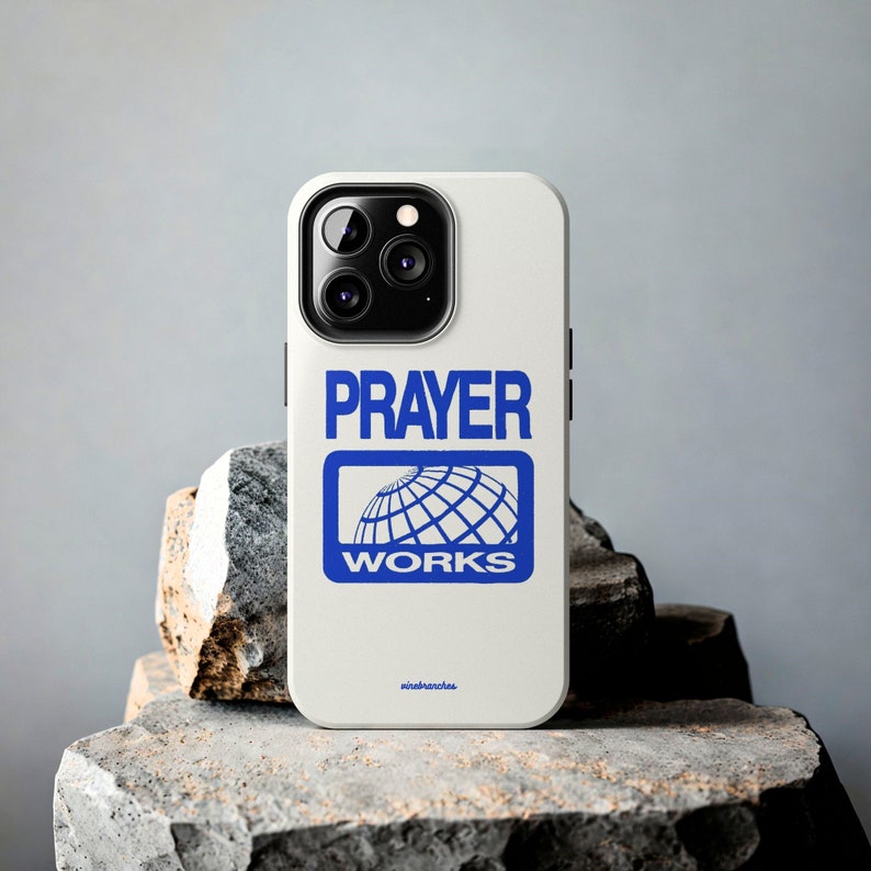 May include: White iPhone case with a blue logo that says "PRAYER WORKS" and a globe graphic.