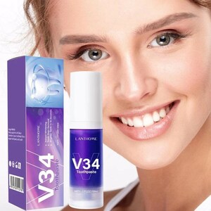 K&ouml;nnte beinhalten: Eine violette und wei&szlig;e Tube V34 Zahnpasta mit dem Text "Instant Whitening Tooth Stain Removal Brighter Teeth in 15 Seconds" und "NET 1 FLOZ/30ml".