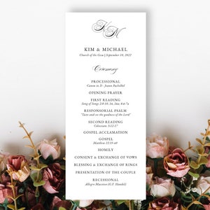 May include: A wedding ceremony program with the names Kim & Michael and the date September 10, 2022. The program lists the order of events for the ceremony, including the processional, readings, and recessional.