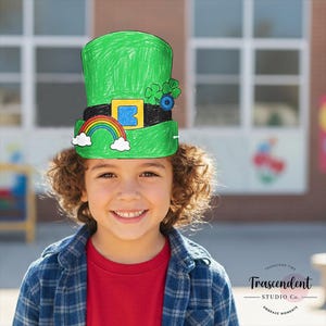 May include: A green St Patrick's Day hat with a black band, yellow buckle, rainbow, and shamrock decorations. The hat is worn by a smiling child. The child is wearing a red shirt and a blue plaid shirt.