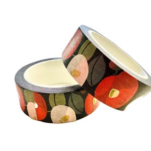 May include: Two rolls of decorative washi tape. The tape features a floral pattern with red, pink, and cream-colored flowers and green leaves on a black background. The tape is designed for crafts, scrapbooking, and other creative projects.