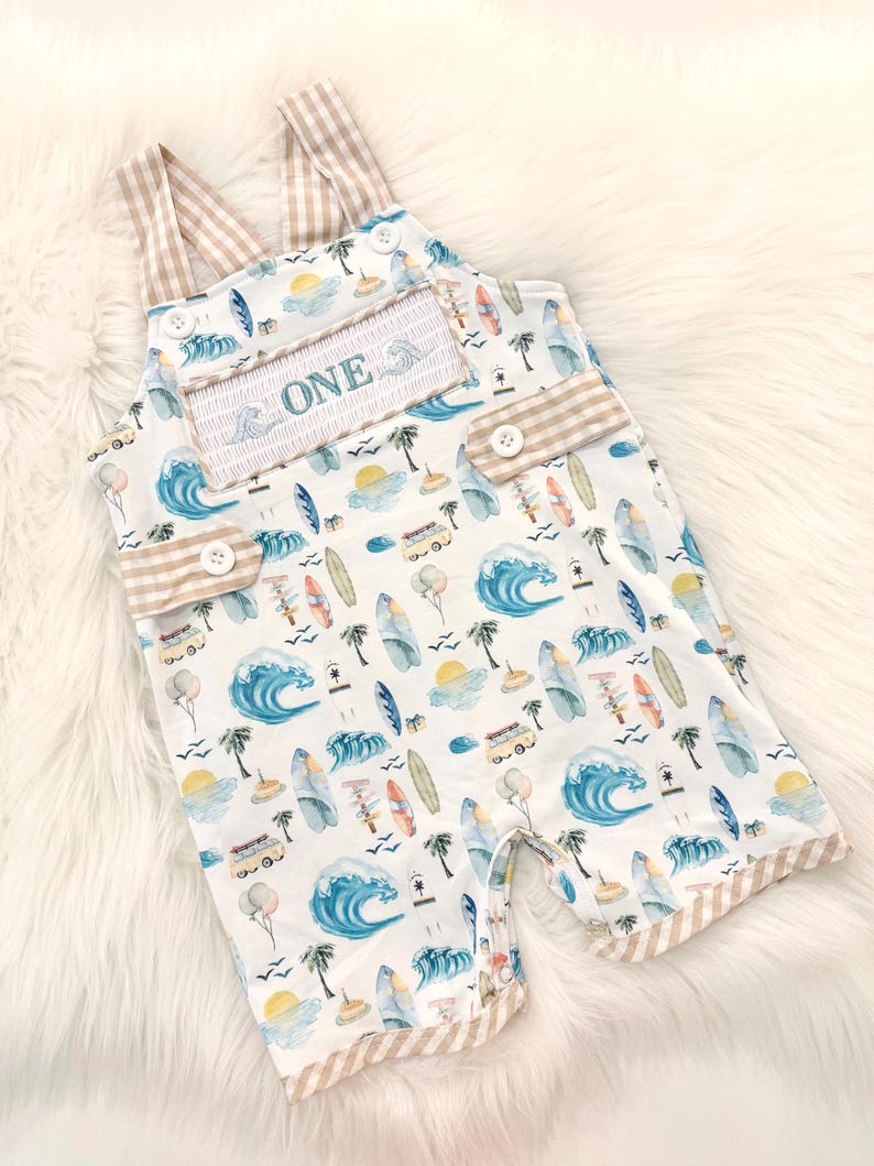the big one first birthday boy romper my first wave summer beach surfer aqua blue tan white gingham yellow smash cake outfit overalls, ONE smocked romper first birthday beach party surfing, ocean embroidered smocked spring summer 1st birthday boy outfit romper baby boys