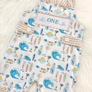 the big one first birthday boy romper my first wave summer beach surfer aqua blue tan white gingham yellow smash cake outfit overalls, ONE smocked romper first birthday beach party surfing, ocean embroidered smocked spring summer 1st birthday boy outfit romper baby boys