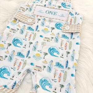 the big one first birthday boy romper my first wave summer beach surfer aqua blue tan white gingham yellow smash cake outfit overalls, ONE smocked romper first birthday beach party surfing, ocean embroidered smocked spring summer 1st birthday boy outfit romper baby boys