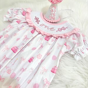 pink bow first birthday girl romper pink and white outfit, pink white smocked bubble romper first birthday winter bows ruffle bows  embroidered smocked long sleeve 1st birthday outfit romper baby girls the mod mango baby boutique