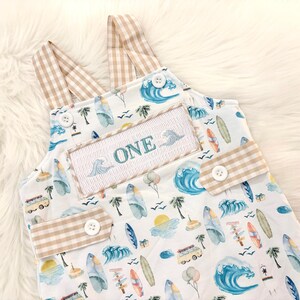 the big one first birthday boy romper my first wave summer beach surfer aqua blue tan white gingham yellow smash cake outfit overalls, ONE smocked romper first birthday beach party surfing, ocean embroidered smocked spring summer 1st birthday boy outfit romper baby boys