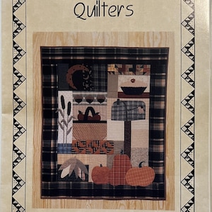 May include: A quilt pattern titled "Kansas Troubles Quilters" featuring a patchwork design with autumn-themed elements. The quilt design includes pumpkins, leaves, and a mailbox. The words "Autumn Days" and the number "#9523" are also visible.