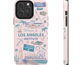 May include: A light pink phone case with a Los Angeles design. The case features illustrations of palm trees, buildings, and the text "Welcome to Los Angeles Institute." The case also has a black camera module.