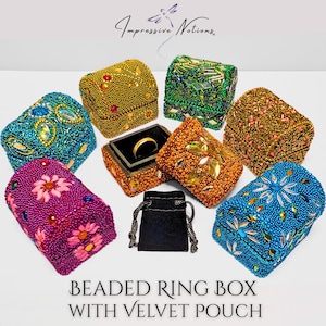 May include: A collection of beaded ring boxes in various colors, including gold, green, orange, blue, and purple. Each box is intricately decorated with beads and gemstones. A black velvet pouch is also included. The text on the image reads "BEADED RING BOX WITH VELVET POUCH."