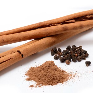 May include: Two cinnamon sticks, ground cinnamon powder, and a pile of black peppercorns.