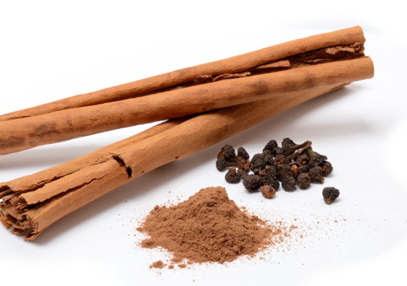May include: Two cinnamon sticks, ground cinnamon powder, and a pile of black peppercorns.