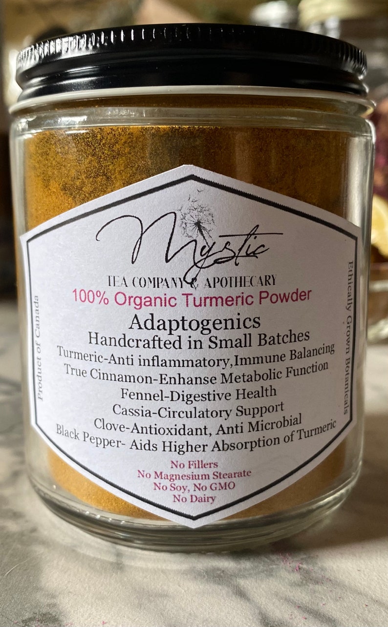 May include: A glass jar filled with golden turmeric powder. The label reads "100% Organic Turmeric Powder Adaptogenics Handcrafted in Small Batches" and lists the benefits of turmeric, including anti-inflammatory, immune balancing, and digestive health. The label also states "No Fillers, No Magnesium Stearate, No Soy, No GMO, No Dairy".