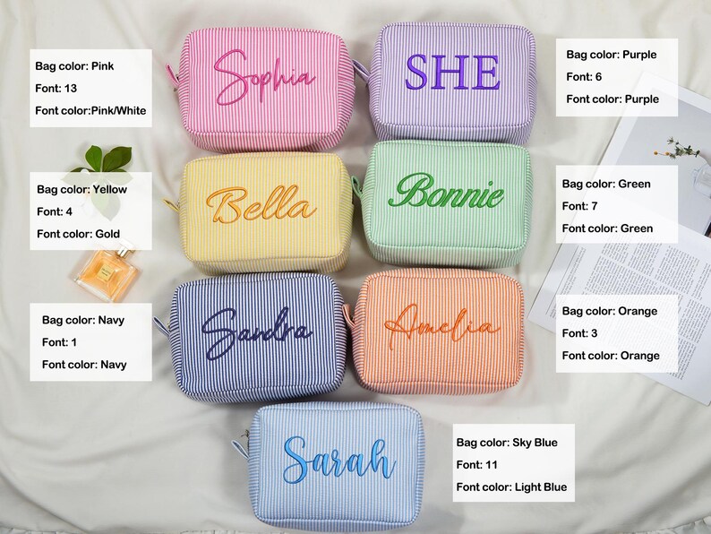 May include: A collection of personalized cosmetic bags in various colors, including pink, purple, yellow, green, orange, navy, and sky blue. Each bag features a name or word embroidered in a coordinating color, with a striped pattern.