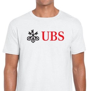 May include: White t-shirt with a black key logo and the text "UBS" in red.