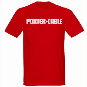 May include: A red t-shirt with the white text "PORTER+CABLE" across the chest. The text has a diamond shape between the words. The shirt is a short-sleeved crew neck.